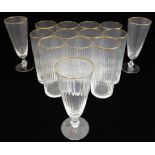 A set of 11 Murano fluted water glasses with gilded rims (14 cm) and three matching wine glasses (15