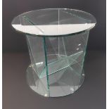 A heavy circular Designer glass table with internal magazine rack (45 cm in diameter and 42 cm