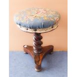 An early Victorian upholstered rosewood adjustable music stool: floral needlework top, barleytwist