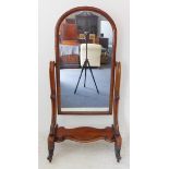 A large early Victorian mahogany framed cheval mirror: the cushion-moulded frame flanked by two