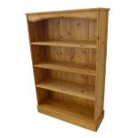A large and modern pine open bookcase on plinth base (83cm wide x 29cm deep x 124cm high)