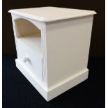 A modern cream painted pine bedside unit: the moulded top an open shelf section and single drawer