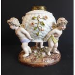 A late 19th century hand-decorated continental porcelain lamp-base: modelled as three cherubs