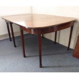 A large 19th century extending mahogany D-end dining table with two extra leaves: raised on square