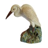 A life-size ceramic model of a heron stepping through reeds: majolica glazes, probably mid-20th