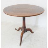 A mid-18th century circular tilt-top oak occasional table with birdcage mechanism: the circular