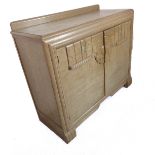 An Art Deco period bleached oak side cabinet: two doors opening to reveal shelf space and two