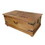 A modern Eastern-style bound trunk / coffee-table on castors: two hinged opening end-flaps (110 cm