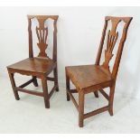 A pair of unusual 18th century elm side chairs: pierced splats, solid seats, shaped front friezes