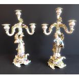 A pair of late 19th century figural German porcelain four-light candelabra: meticulously applied