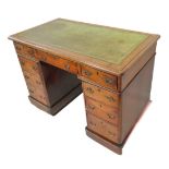 A late 19th century mahogany pedestal desk: the green inset tooled-leather top above an