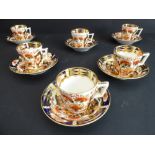 A set of six Derby coffee cans and saucers, each hand-decorated and gilded in the Imari palette