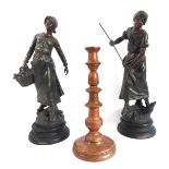 A pair of late 19th century French spelter figure models of peasants at work, raised on turned