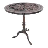 A tripod table (possibly rosewood) circa 1900, the top profusely carved with Japanese scenes of