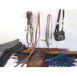 A selection of equestrian equipment comprising: 5 padded girths; 3 padded numnahs; 2 pairs of