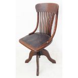 An early 20th century oak swivel desk chair: in original condition, the concave top rail above