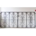 A pair of wrought-iron gates with black-painted scrolling decoration (each gate 118 cm x 130 cm)