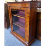 A 19th century walnut pier cabinet: the frieze with a marquetry design above a single boxwood strung