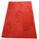 A very heavy Eastern handmade rug of plain red colour with sculptured design, G H Frith label (183cm