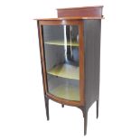 An early 20th century bow-fronted mahogany and chequer-strung display cabinet: galleried top above