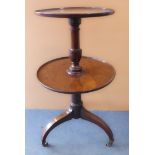 A late 18th / early 19th century two-tier circular mahogany dumb-waiter: turned stem and on three