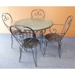 An industrial-style circular metal garden table on four shaped legs and four matching chairs (94.5