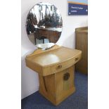 An Art Deco period bleached bow-fronted oak dressing table: stylised iron handle with pierced leaf
