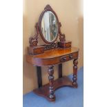 A mid-19th century Duchess-style dressing table: oval mirror flanked by two carved supports and