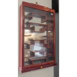 A heavy Chinese hardwood wall-hanging display cabinet: the single glazed door with key fret-style