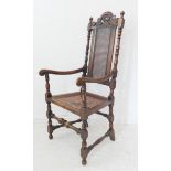 An early 20th century stained beech open armchair in high late 17th century style: arched and