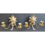 A pair of early 20th century cast brass two-light wall appliques with cut-glass droppers: the main