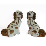 A large pair of 19th century Staffordshire copper lustre pottery spaniels (31.5cm high)