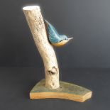 JOHN MAINWARING, a good and realistic wooden carving of a nuthatch on a branch, signed and annotated
