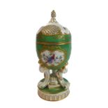 A 19th century continental porcelain potpourri of egg shape: the finely gilded pierced dome-topped