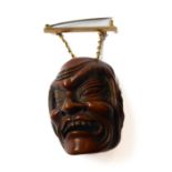 A very finely carved Japanese wooden Noh mask (Omote): the male figure open-mouthed and alert,