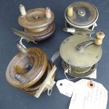 Four late 19th / early 20th century fishing reels: an early 3" ebonite and brass trout reel with