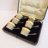 A cased set of six yellow glaze Staffordshire ceramic custard cups within ornate silvered holders (