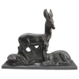 A large ceramic model of a stag, doe and fawn in Art Deco style: matt-black glaze, the plinth base