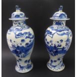 A pair of 19th century Chinese baluster-shaped porcelain vases and covers: each dome-topped cover