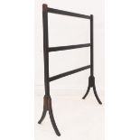 A 19th century ebonised and gilt highlighted towel-rail: slender square sabre-style legs, further