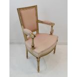 A cream and gilt painted upholstered open armed fauteuil in late 18th century Louis XVI style: the