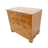 An early 18th century walnut chest: the quarter-veneered, chevron-banded slightly overhanging top