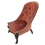 An early Victorian rosewood and buttonback upholstered armchair: lappet carved scrolling arm