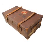 An early 20th century two-handled leather-mounted travelling trunk of large proportions and with