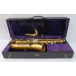 A cased saxophone: the sound horn engraved 'Buescher Elkhart Ind.', the instrument individually