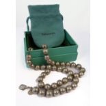 A silver spherical bead necklace by Tiffany: each 10mm sphere strung on a fine chain, Tiffany plaque