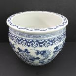 A large and heavy Chinese porcelain ovoid bowl: decorated in underglaze blue with a band of prunus