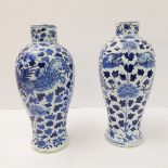 A pair of 19th century Chinese baluster-shaped porcelain vases, each hand-decorated in underglaze