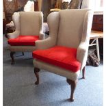 A good pair of early 18th century style (later) wing backed armchairs: each raised on walnut front