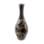 A late 19th/early 20th century silver overlay elongated baluster-shaped ceramic vase with Ruskin-